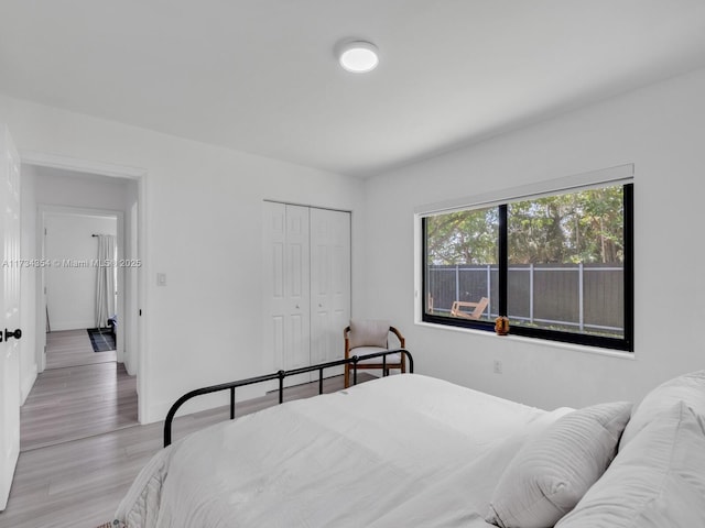 bedroom featuring light hardwood / wood-style floors and a closet