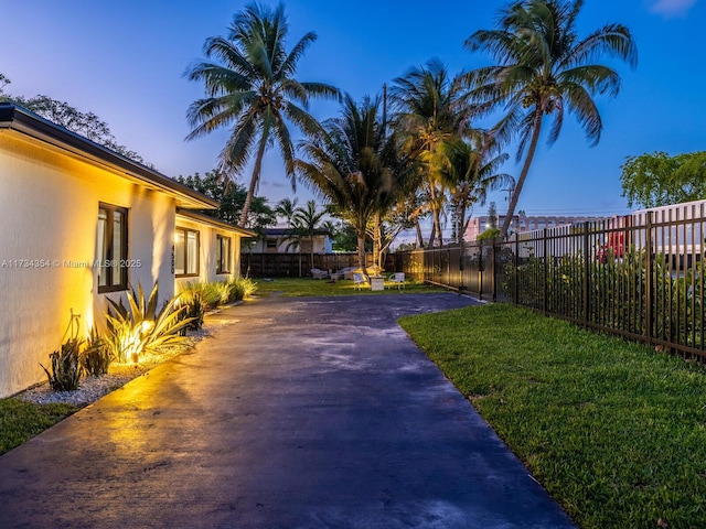 yard at dusk with a patio area