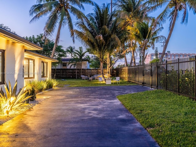 yard at dusk featuring a patio area