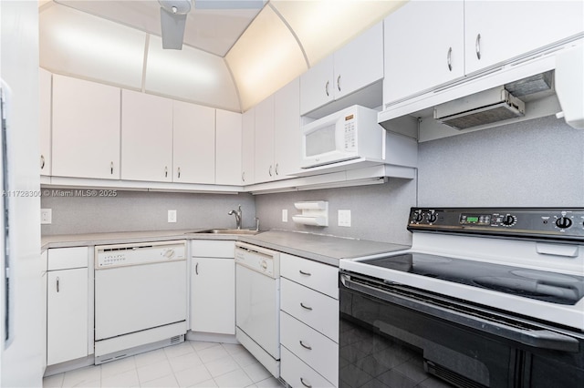 kitchen featuring light tile patterned flooring, white appliances, sink, and white cabinets