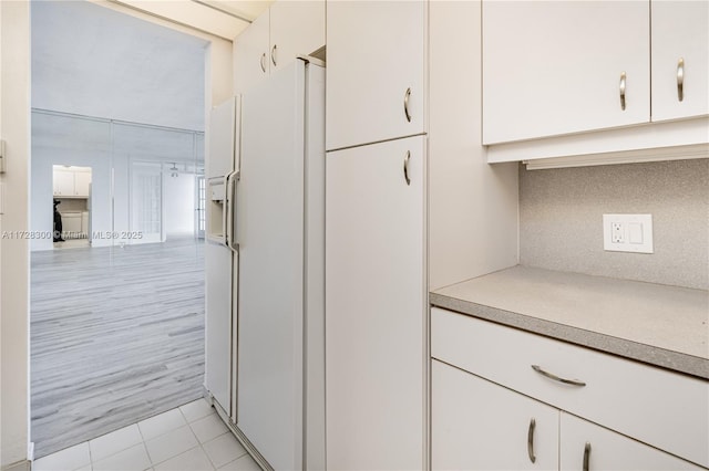 details with tasteful backsplash and white refrigerator with ice dispenser