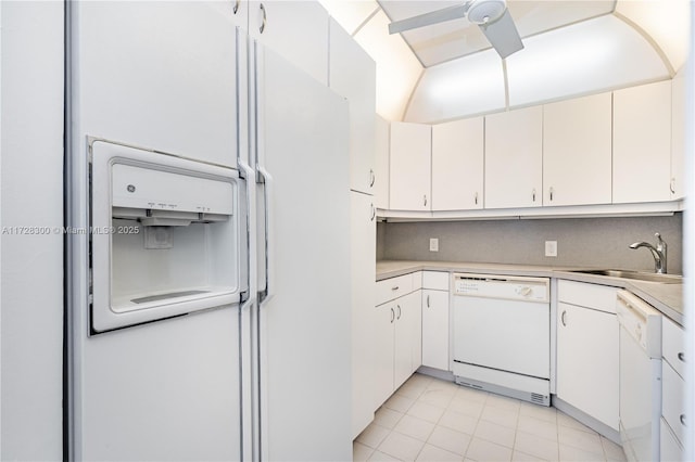 kitchen with sink, white appliances, white cabinets, and light tile patterned flooring