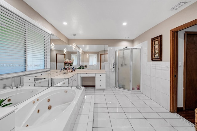 bathroom with tile patterned floors, vanity, visible vents, and a shower stall