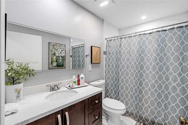 full bathroom with a shower with curtain, vanity, and toilet