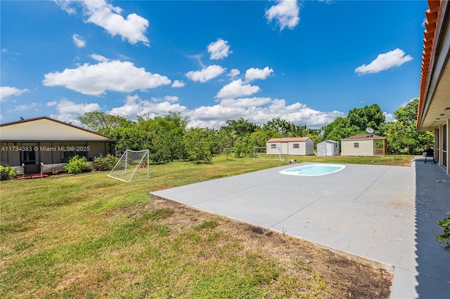 view of basketball court with a yard and a shed