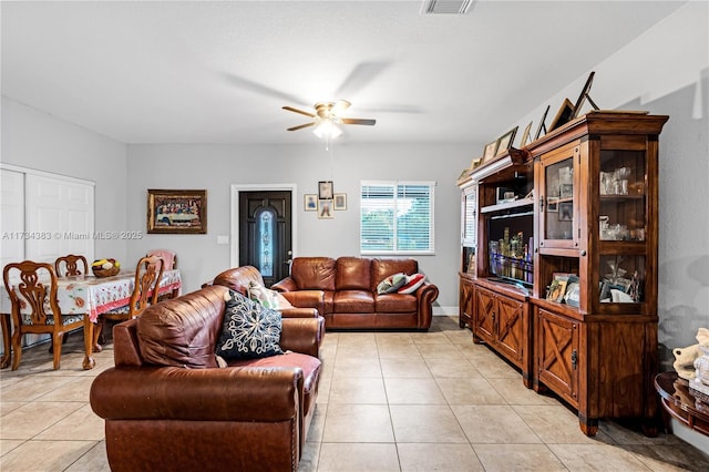 living room with ceiling fan and light tile patterned flooring