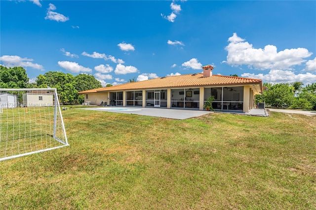 rear view of property with an outdoor pool, a patio, a sunroom, a tile roof, and a chimney