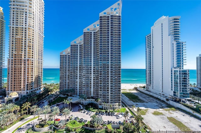 view of property with a water view and a view of the beach