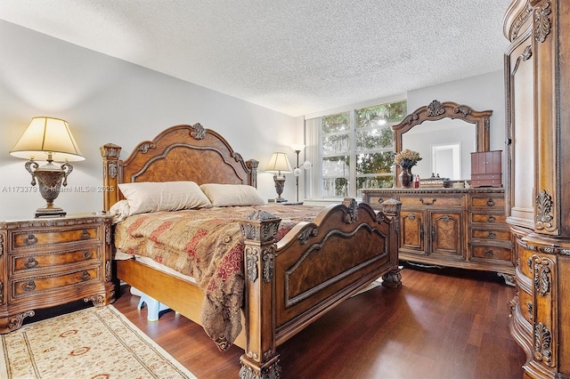 bedroom featuring dark wood-type flooring and a textured ceiling