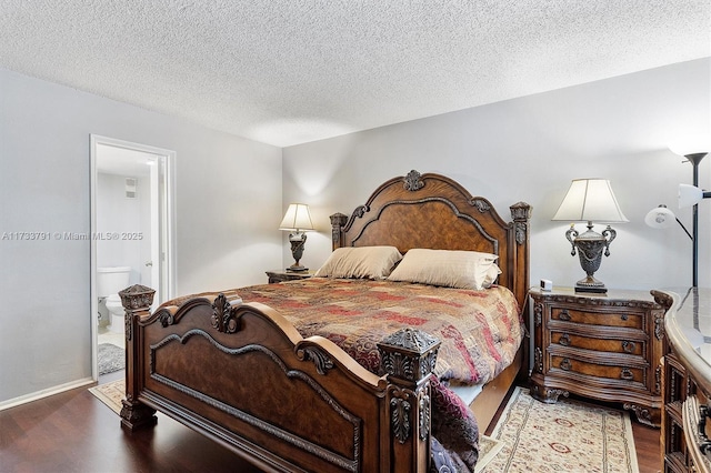 bedroom with hardwood / wood-style flooring, a textured ceiling, and ensuite bathroom