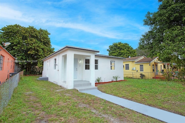 bungalow-style home with a front lawn