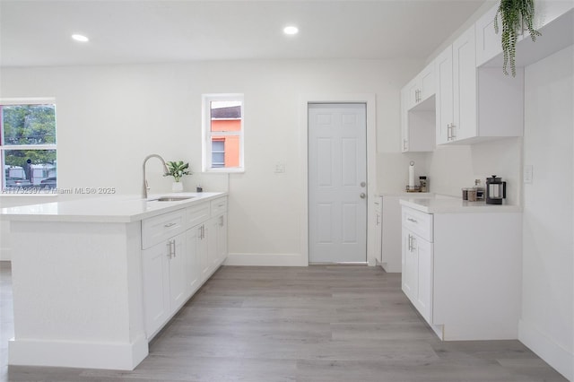 kitchen featuring white cabinetry, plenty of natural light, and sink