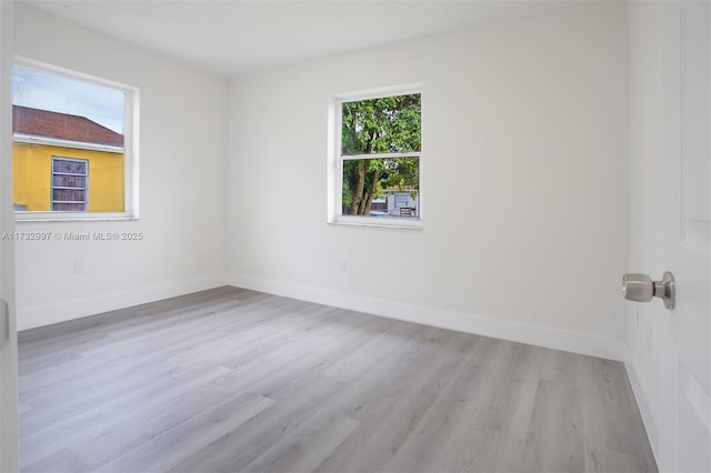 unfurnished room with light wood-type flooring