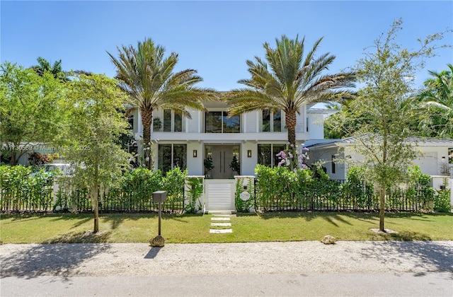 view of front of property featuring a fenced front yard and a front lawn