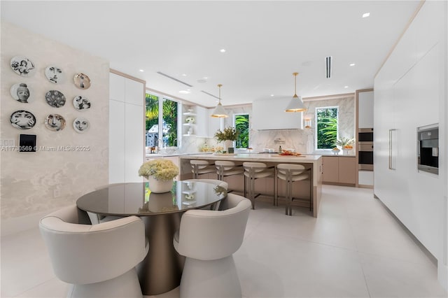 dining area with plenty of natural light and recessed lighting