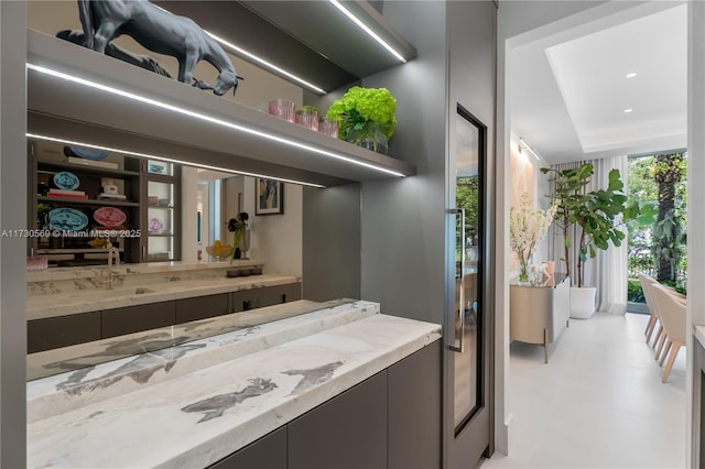 bathroom with floor to ceiling windows and a sink