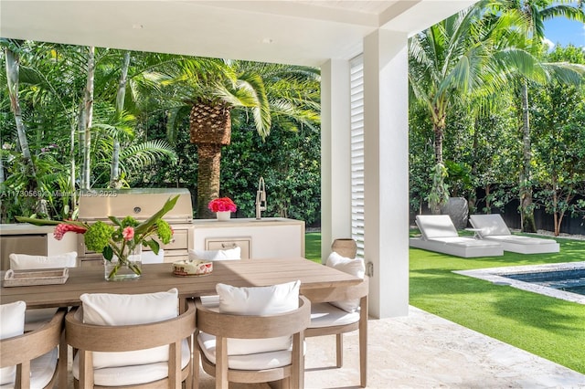 view of patio with outdoor dining area, an outdoor pool, and a sink