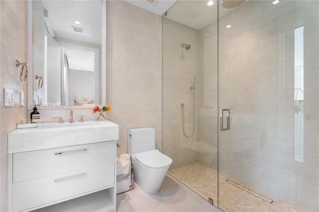 bathroom featuring visible vents, toilet, a stall shower, tile walls, and vanity