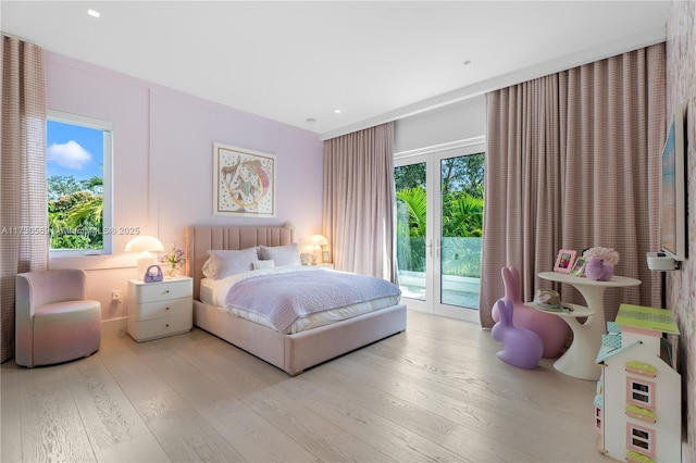 bedroom featuring access to exterior, recessed lighting, and wood finished floors