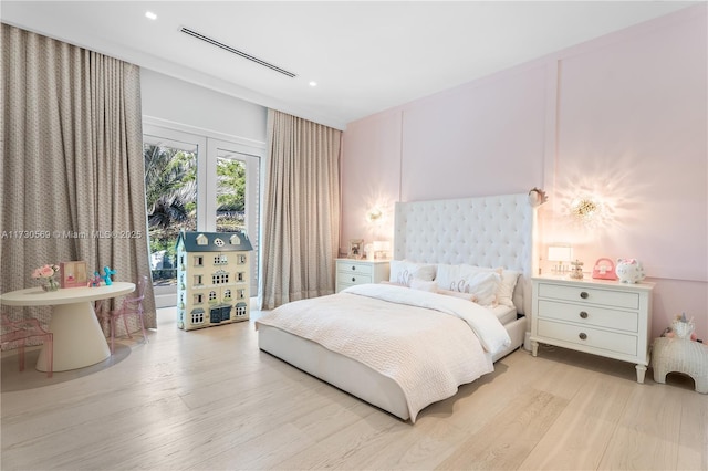 bedroom with visible vents and light wood-style flooring