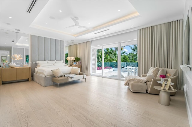 bedroom featuring visible vents, a tray ceiling, light wood-style flooring, recessed lighting, and access to exterior