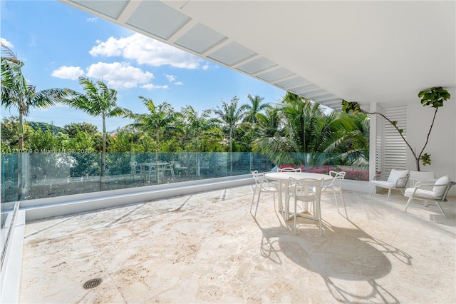 view of patio with outdoor dining area and fence