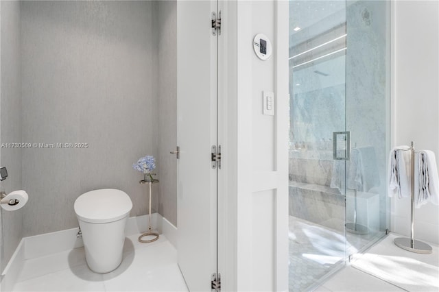 bathroom with a marble finish shower and toilet