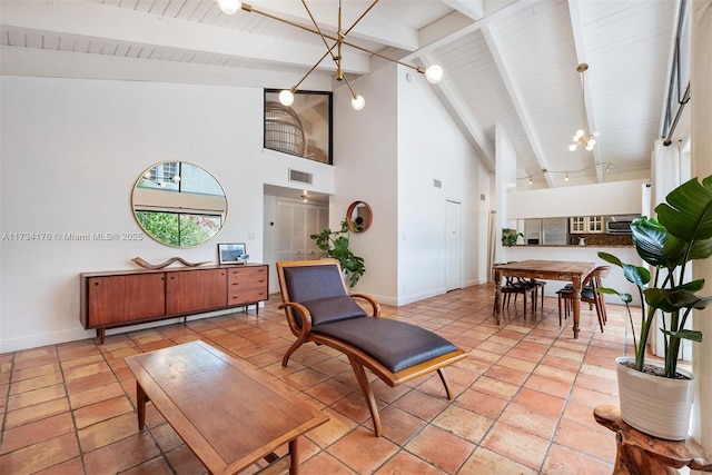 interior space featuring high vaulted ceiling, a chandelier, and beamed ceiling