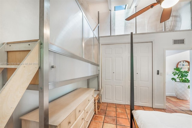 stairs featuring a towering ceiling and tile patterned floors