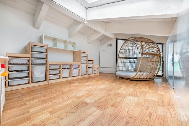 interior space with lofted ceiling with beams, wood ceiling, and light hardwood / wood-style floors