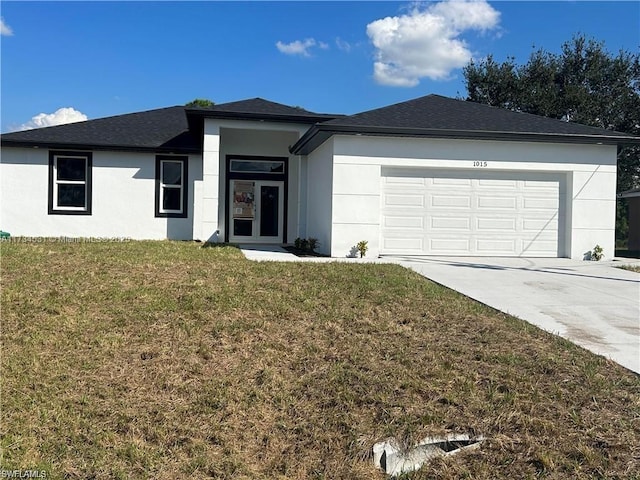 view of front of house with a garage and a front yard