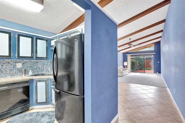 kitchen featuring light tile patterned floors, blue cabinetry, lofted ceiling with beams, black appliances, and decorative backsplash