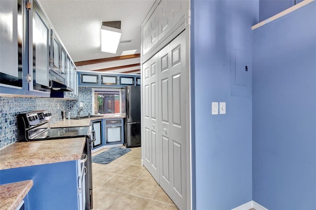 kitchen featuring blue cabinets, stainless steel range with electric stovetop, a textured ceiling, light tile patterned floors, and black refrigerator