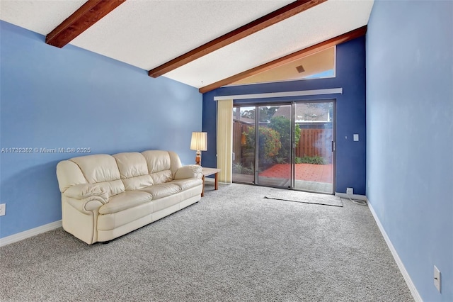 unfurnished living room with lofted ceiling with beams and carpet floors