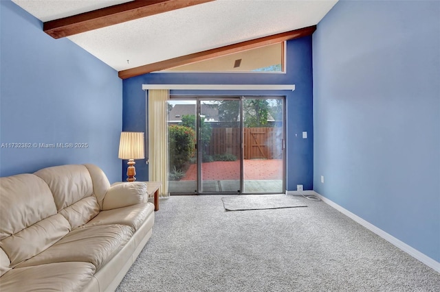 carpeted living room featuring lofted ceiling with beams and a textured ceiling