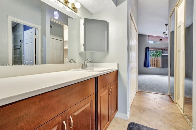 bathroom with vanity, tile patterned flooring, and a textured ceiling