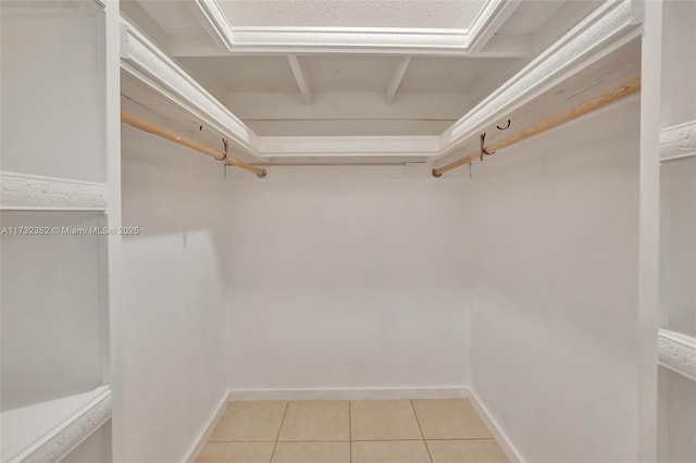 walk in closet with light tile patterned floors