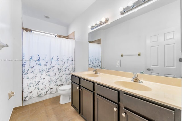 bathroom with vanity, tile patterned floors, and toilet