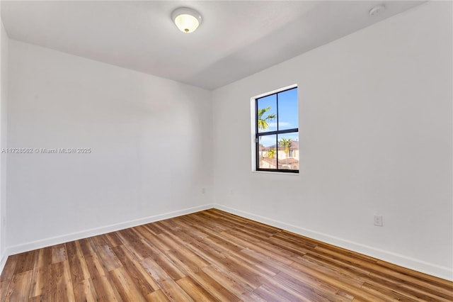 spare room with hardwood / wood-style floors