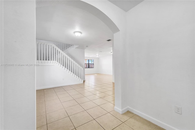 hall with light tile patterned floors