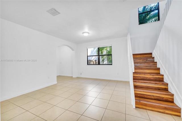 staircase featuring tile patterned flooring