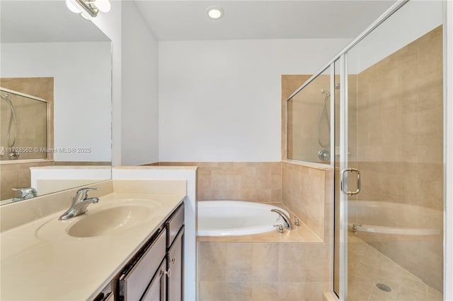 bathroom with vanity and separate shower and tub