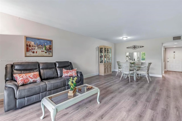 1401 SW 128th Ter Unit 307H, Pembroke Pines, FL 33027 - living room featuring baseboards, wood finished floors, and visible vents