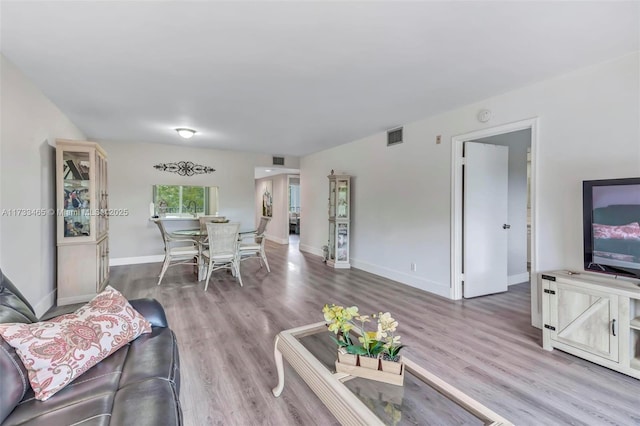 1401 SW 128th Ter Unit 307H, Pembroke Pines, FL 33027 - living area featuring baseboards, wood finished floors, and visible vents