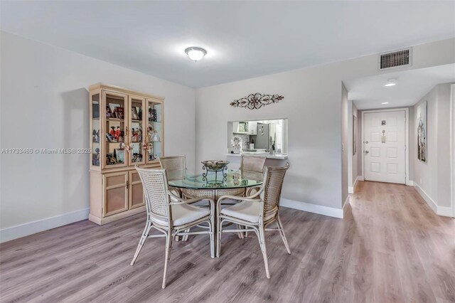 1401 SW 128th Ter Unit 307H, Pembroke Pines, FL 33027 - dining room with baseboards, light wood-style flooring, and visible vents