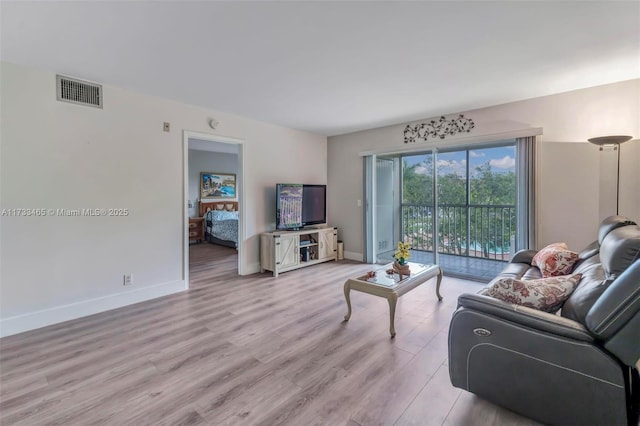 1401 SW 128th Ter Unit 307H, Pembroke Pines, FL 33027 - living area with baseboards, visible vents, and light wood finished floors