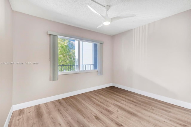 1401 SW 128th Ter Unit 307H, Pembroke Pines, FL 33027 - spare room featuring baseboards, ceiling fan, a textured ceiling, and wood finished floors