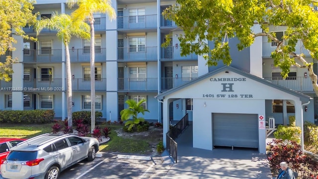 1401 SW 128th Ter Unit 307H, Pembroke Pines, FL 33027 - view of building exterior featuring an attached garage