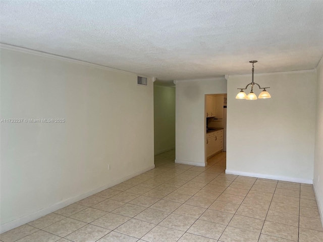 empty room featuring crown molding, a textured ceiling, and a chandelier