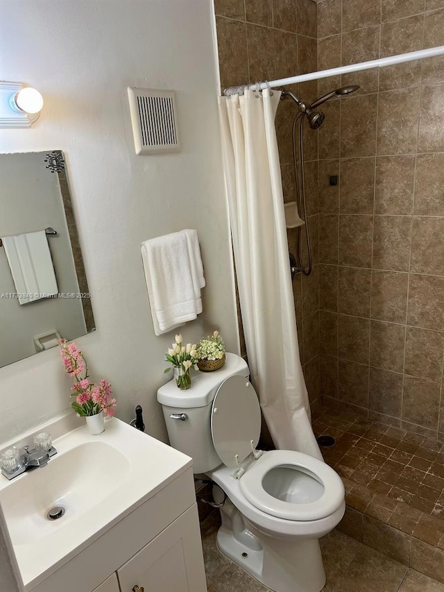 bathroom featuring vanity, toilet, and walk in shower